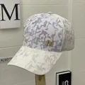 White trucker hat with colorful camo print, gold metal M emblem and breathable mesh - Full Camouflage White