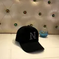 Detailed close-up of a fuzzy black baseball cap with a sparkling rhinestone N design - Adult Size (56-60cm) / N Black