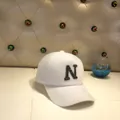 Close-up of white plush baseball cap featuring a sparkling sequined N letter applique - Adult Size (56-60cm) / White (N)