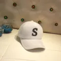 Detail shot of white mink fur baseball cap with black sequined S letter logo - Adult Size (56-60cm) / Letter S / White