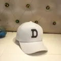 Detailed view of white faux mink baseball cap with shimmering black rhinestone D letter - Adult Size (56-60cm) / Letter D / White