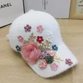 Close-up of plush white baseball cap with 3D floral, pearl, and rhinestone embellishments - Lace Large Flower Style / White
