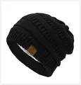 Black knitted beanie with star leather patch and warm white sherpa fleece lining - Black