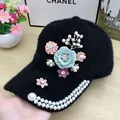 Detail of plush black baseball cap with 3D fabric flowers and pearl brim decorations - Pearl Flower Style / Black