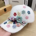 White plush baseball cap featuring colorful 3D floral accents and sparkling rhinestones - Flower Style / White