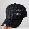 Detail of black lace baseball cap featuring a silver metallic M emblem and tweed texture - Adult Size (Adjustable) / Black