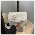White faux suede saddle bag with wide fabric strap and golden metal buckle - White