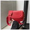 Minimalist red suede saddle bag with adjustable wide strap and gold hardware accents - Red