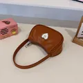 Brown half-moon underarm bag with a crystal heart patch and metallic butterfly - Brown