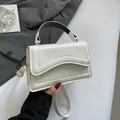 Minimalist white leather handbag with wave quilted stitching and golden hardware - White