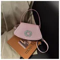 Pink glitter crossbody bag with sparkling rhinestone buckle on a fashion magazine - Pink