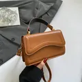 Brown leather crossbody bag with wave texture, golden hardware and top handle design - Brown