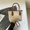Minimalist cream and brown two-tone tote bag with litchi grain texture and metal logo - White