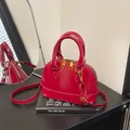 Glossy red shell-shaped handbag with gold hardware and detachable shoulder strap - No Pendant / Red