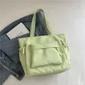 Minimalist light green nylon tote bag with functional pockets and white string zippers - Green