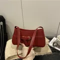 Minimalist deep red leather shoulder bag with buckle detail and sleek underarm design - Red