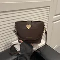 Retro dark brown leather bucket bag with gold heart buckle and wide strap for women - Brown