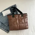 Stylish brown quilted puffer tote bag with black webbed handles for women - Brown