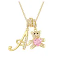 Detailed close-up of golden bear pendant with pink heart stone and letter A necklace - Letter A / Gold
