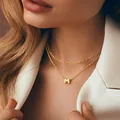 Close-up of layered gold paperclip chain and beaded necklace with letter M pendant - Letter M(A) / Gold