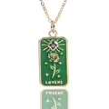 Detail of retro tarot-style necklace featuring a green enamel rose pendant and purple gem - Green