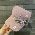 Detail of knitted sun visor with colorful 3D fabric flowers and golden metal leaves - Adult Size (Adjustable) / Pink