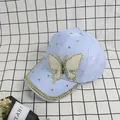 Close-up of light blue baseball cap with pearl butterfly patch and golden rhinestones - Adult Size (Adjustable) / Light Blue