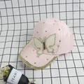 Close-up of pink fashion baseball cap with pearl butterfly patch and golden rhinestones - Adult Size (Adjustable) / Pink