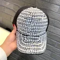 Detailed view of a black baseball cap fully covered in shimmering white rhinestones - Adult Size (Adjustable) / Black AB Iridescent Pearl