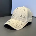 Detailed view of beige baseball cap featuring rhinestone letters and breathable mesh back - Adult Size (Adjustable) / Off White