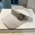 Detail of white sun visor featuring shimmering rhinestone band and metallic square buckle - Adult, Adjustable / White