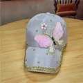 Macro detail of lavender glitter baseball cap with sequined butterfly and pearl accents - Adjustable / Blue Butterfly Cloth Style