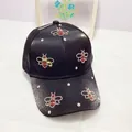 Detailed view of rhinestone bee patterns and large crystals on black satin baseball cap - Adult Size (Adjustable) / Black