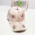 Detail of pink satin baseball cap featuring rhinestone bee embroidery and shiny finish - Adult Size (Adjustable) / Pink