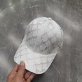 Detailed view of a white baseball cap with sparkling rhinestone jacquard letter pattern - Adult, Adjustable / White (M Letter)