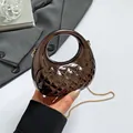 Dark brown quilted metallic crossbody bag with round handle and gold chain strap - Gunmetal