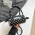 Polka dot cylindrical handbag with gloss finish and detachable black shoulder strap - Black