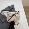 White square crossbody bag with black bow prints and chain strap in a fashion set - Off White