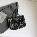Black quilted tote bag with wave embroidery and sleek leather shoulder straps - Black without Pendant
