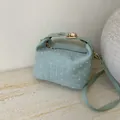 Bolso bandolera verde menta con puntos blancos texturizados y cierre de metal dorado - Verde