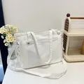 White nylon multipurpose tote bag with transparent front pocket and adjustable shoulder strap - Off White