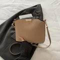 Minimalist khaki bucket bag with gold metal accents and thin leather shoulder strap - Khaki
