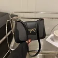 Minimalist grey woven shoulder bag with a black leather trim and a golden bow buckle - Black