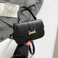 Sac bandoulière noir minimaliste en cuir litchi avec boucle dorée et poignée unique - Noir