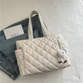 Chic beige quilted puffer shoulder bag with a plush monster charm and side pocket - With Charm / Off White