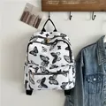 Modieuze witte nylon rugzak met zwarte vlinderprint voor dames en casual reizen - Zwarte vlinderhanger