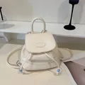 Minimalist cream faux leather backpack for women with beaded drawstring and top handle - White
