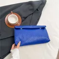 Royal blue woven envelope clutch bag with gold buckles and minimalist texture - Blue