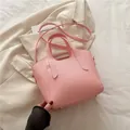 Chic soft pink litchi grain tote bag with dual handles and adjustable shoulder strap - Pink