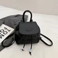 Minimalist black faux leather mini backpack with drawstring closure and bead charms - Black